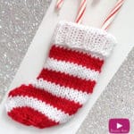 Knitted mini stocking in red and white stripes.