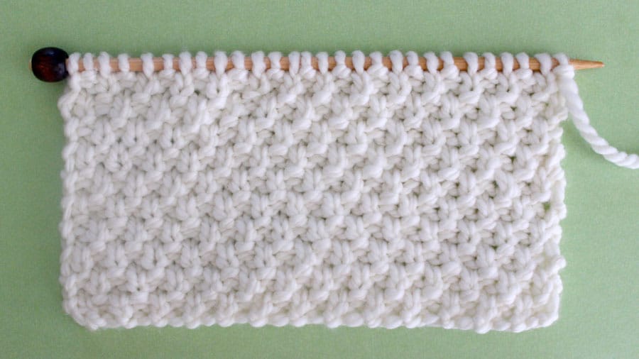 Irish Moss Knit Stitch Pattern. Get Free Written Patterns, Charts, and Video Tutorials in the Absolute Beginner Knitting Series by Studio Knit.