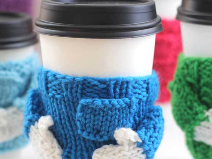 Knitted Coffee Cozy in sweater shape with blue yarn color.