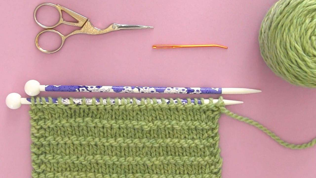 Knitting Materials yarn, knitting needles, scissors, and tapestry needle