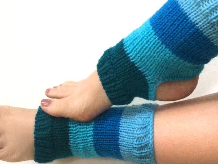 Knitted Yoga Socks on two feet in blue yarn colors.