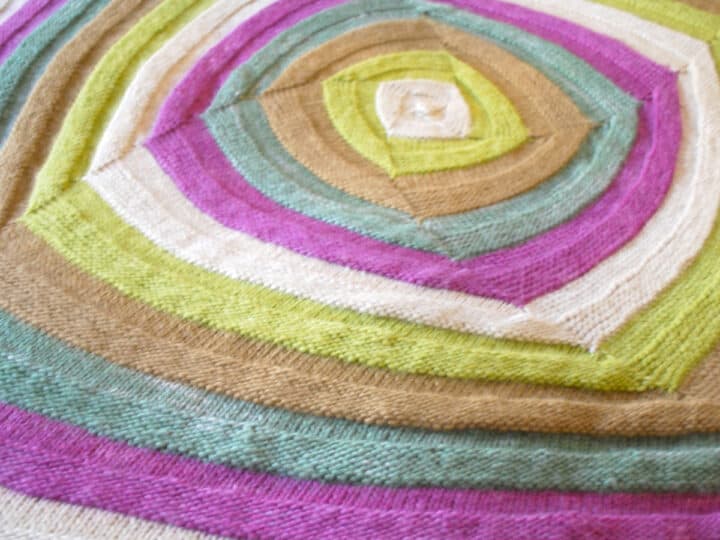 Swirly Square Knit Stitch Pattern texture in multiple yarn colors.