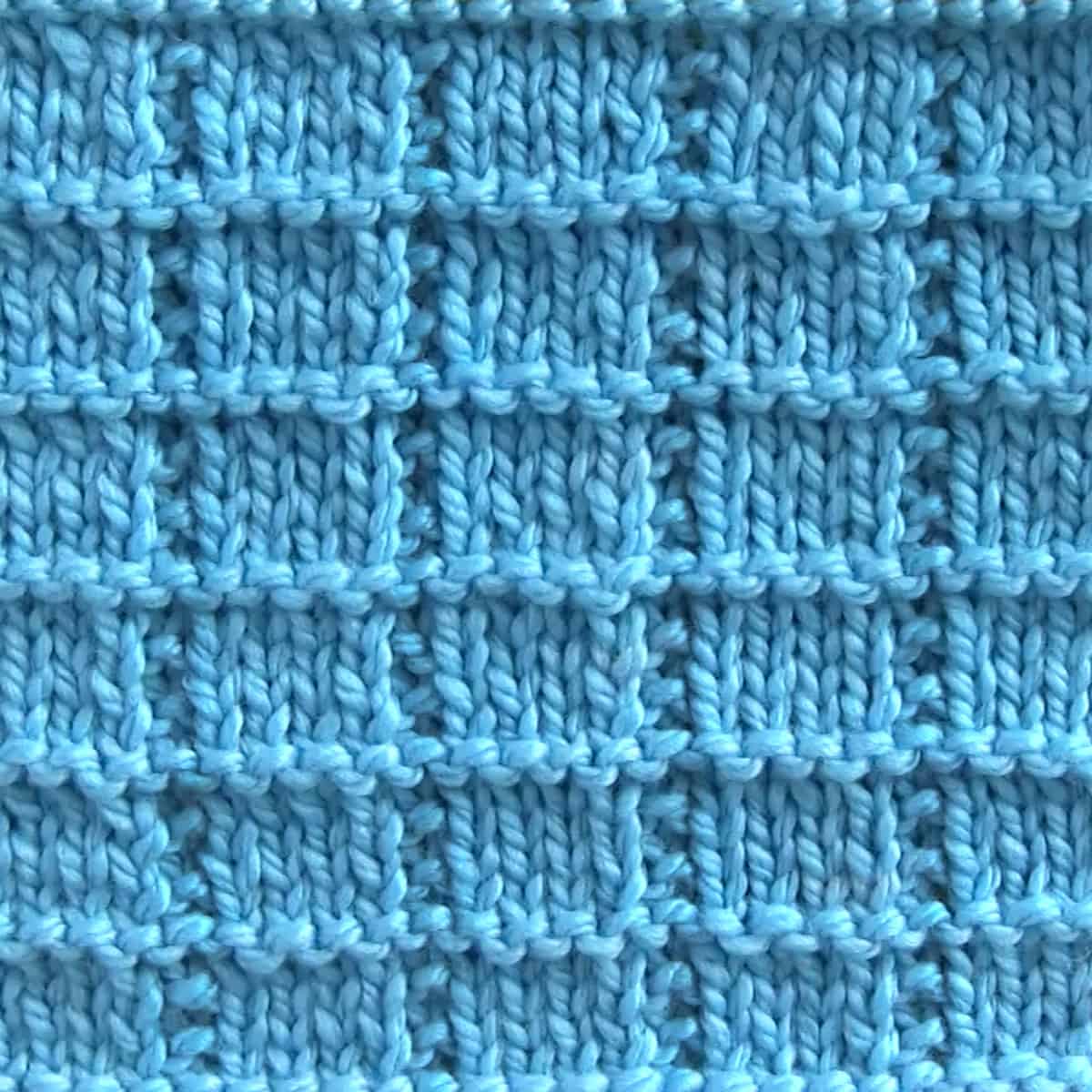 Tile Squares knit stitch pattern with blue colored yarn.