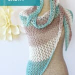 Knitted mesh shawl in displayed on a mannequin in colors blue, brown, and white.