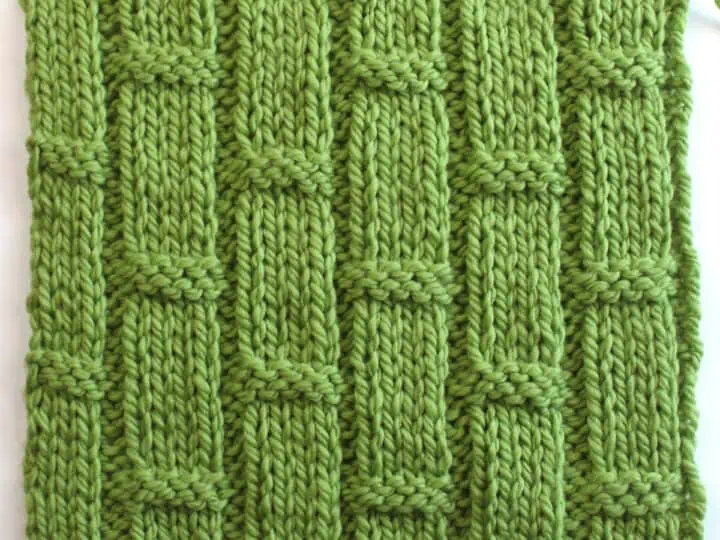 Bamboo Ribbing texture knitted in green colored yarn on bamboo needle.