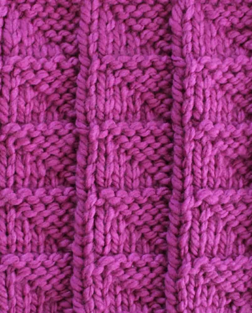 6-10 Row Repeat of Flag stitch knitted in purple yarn color.