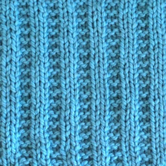 Garter ribbing stitch knitted in blue yarn color.