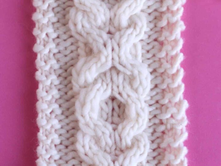 XO Cable textured pattern knitted on straight needles with white colored yarn.