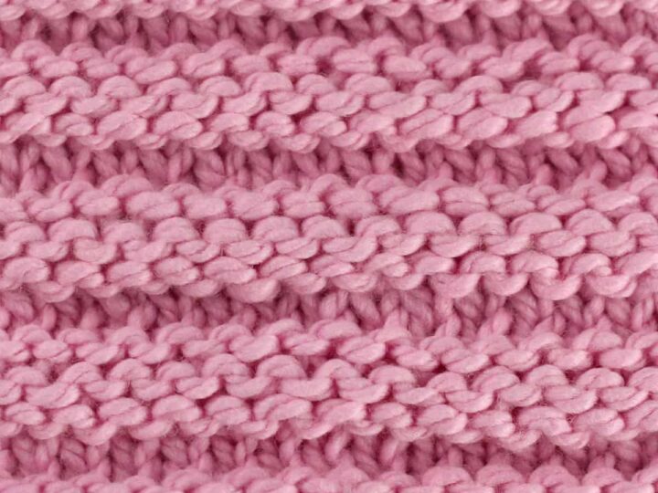 Reverse Ridge knit stitch texture in pink yarn color.