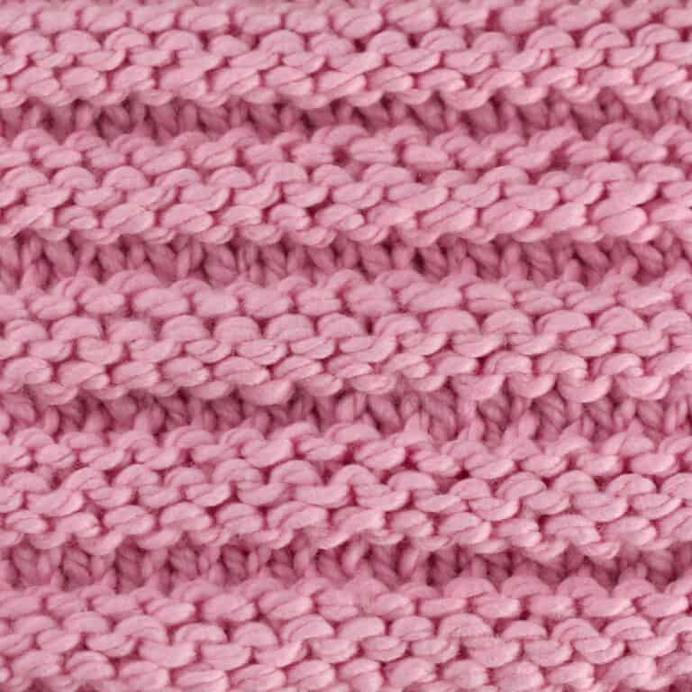 Reverse Ridge knit stitch texture in pink yarn color.