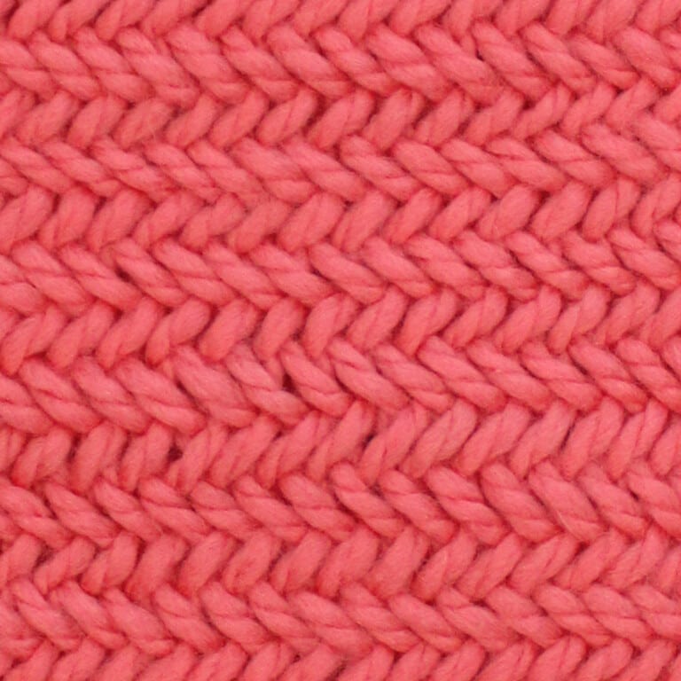 Horizontal Herringbone knit stitch pattern in orange colored yarn.