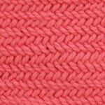 Horizontal Herringbone stitch knitting pattern by Studio Knit in orange-colored yarn.