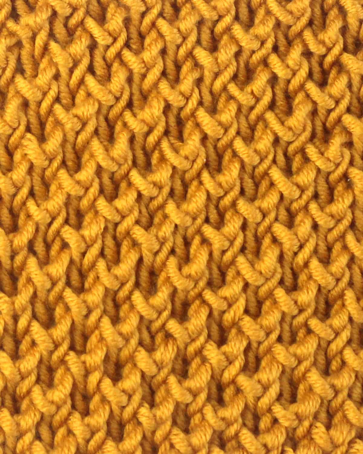 Bee stitch brioche knit stitch pattern in yellow colored yarn.