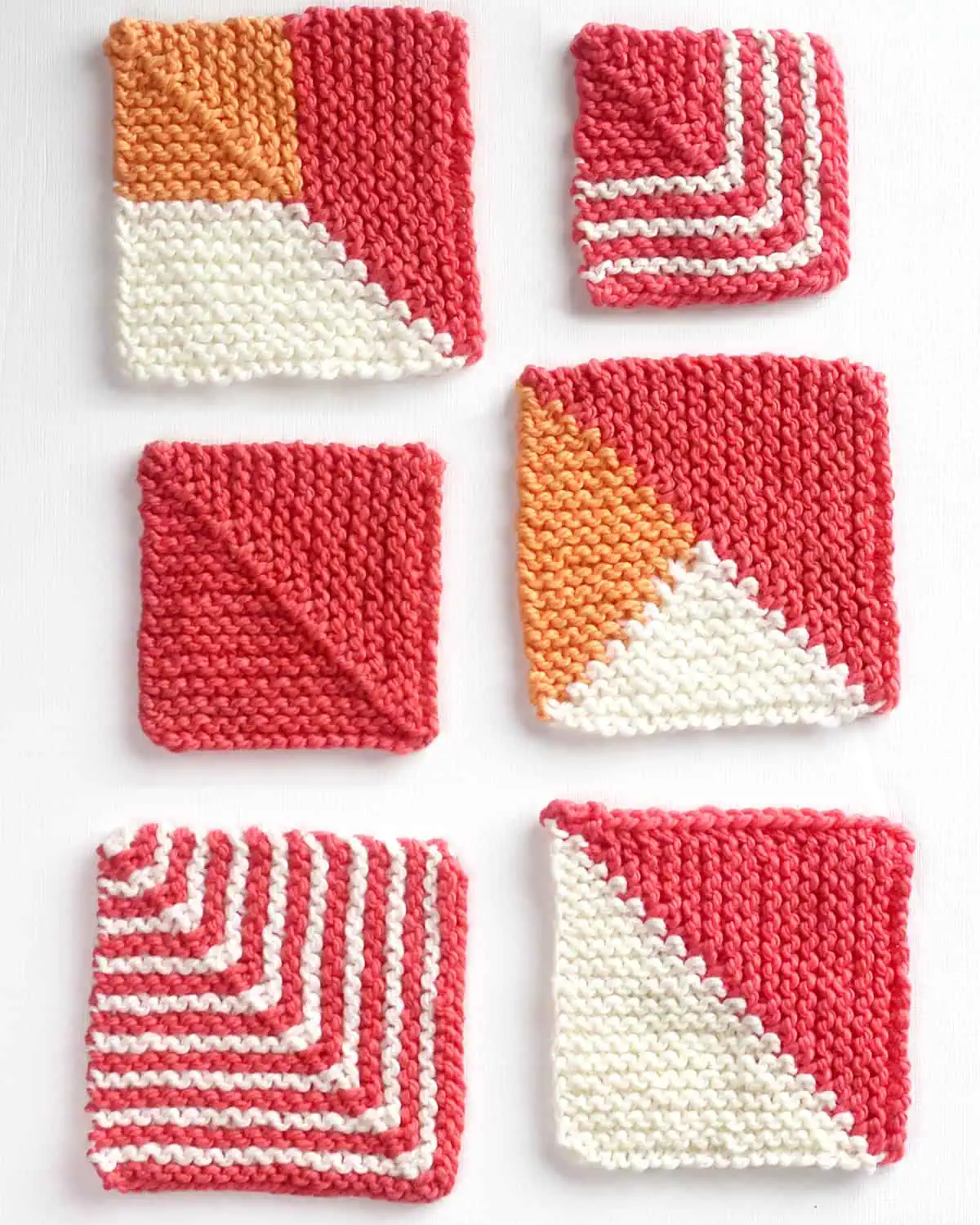 Collection of six different knitted mitered squares in various colorblock patterns with white, pink, and orange colored yarn.