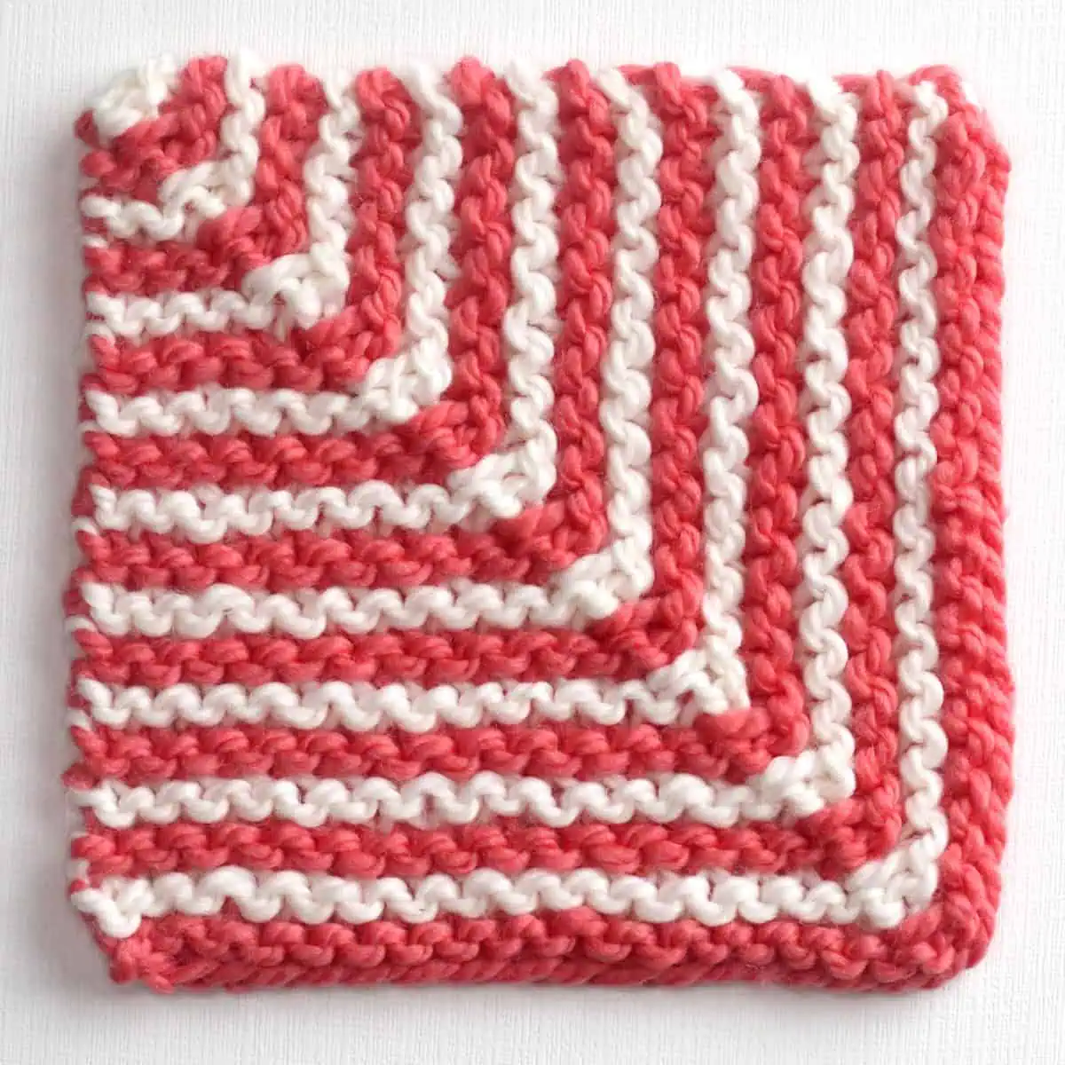 Knitted Mitered Square Striped Design Pattern with two yarn colors in white and pink.