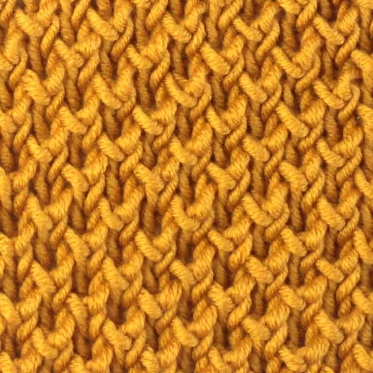 Bee stitch brioche knit stitch pattern in yellow colored yarn.