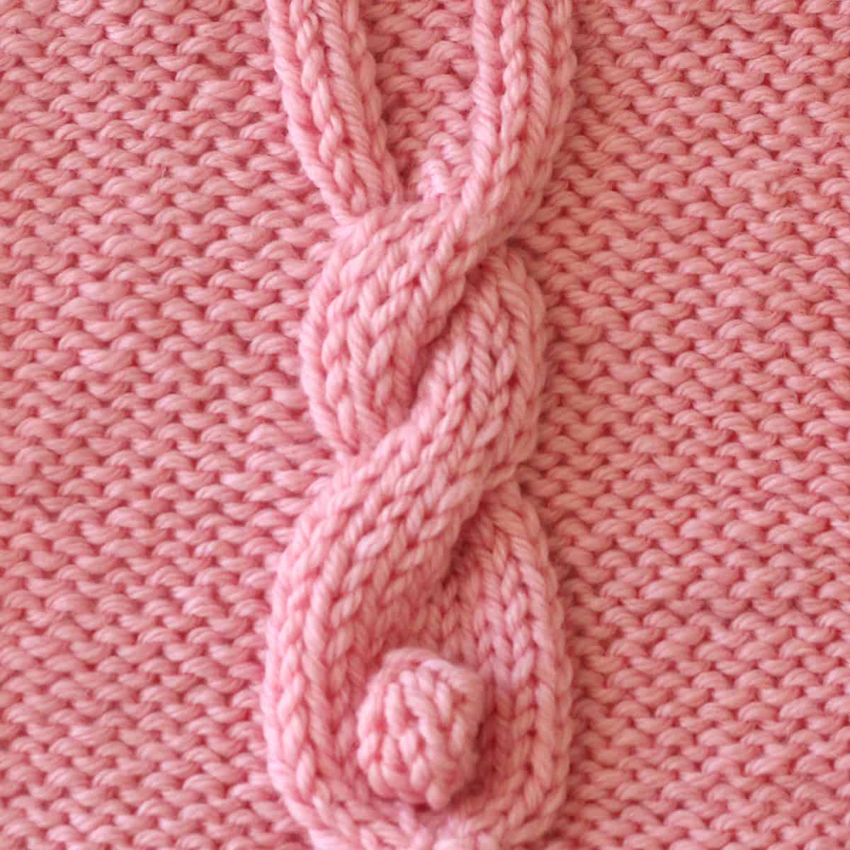 Bunny Cable knitting square in pink yarn color.