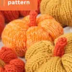 Knitted pumpkin softies in orange and yellow yarn colors.