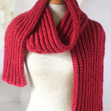 Hot Frosty Scarf designed with Seeded Rib Stitch knitted in red colored yarn.