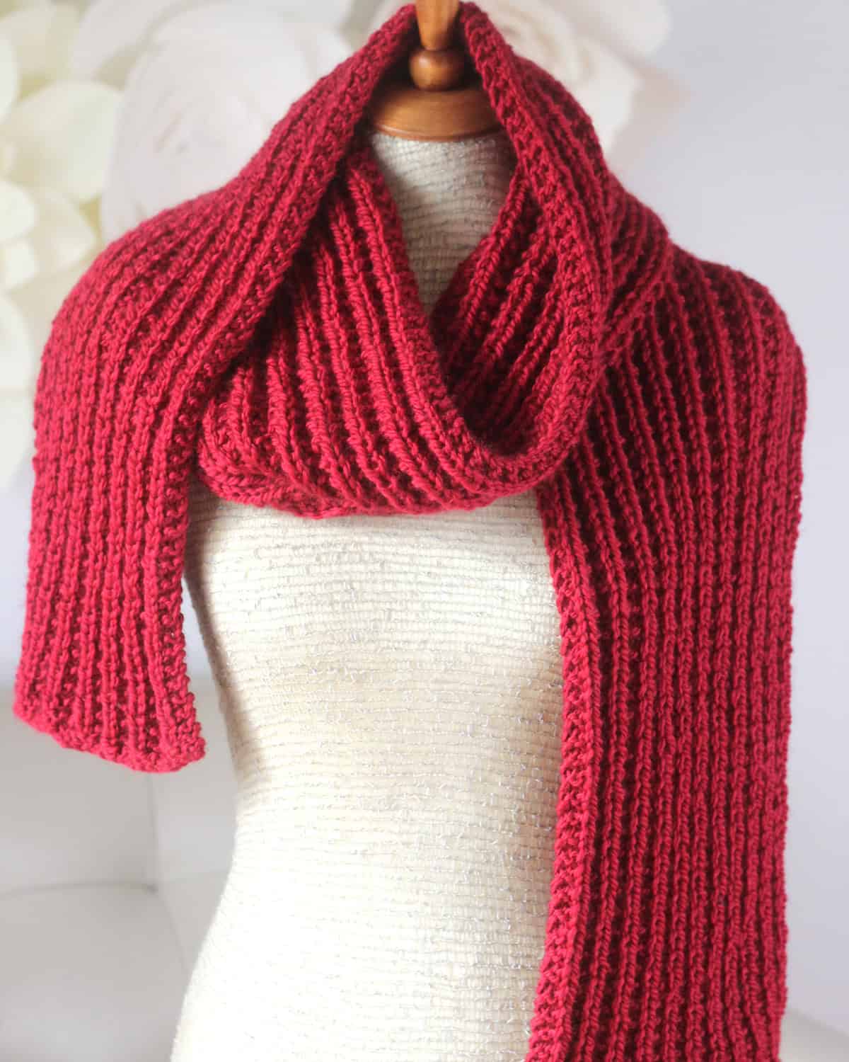 Hot Frosty Scarf designed with Seeded Rib Stitch knitted in red colored yarn.